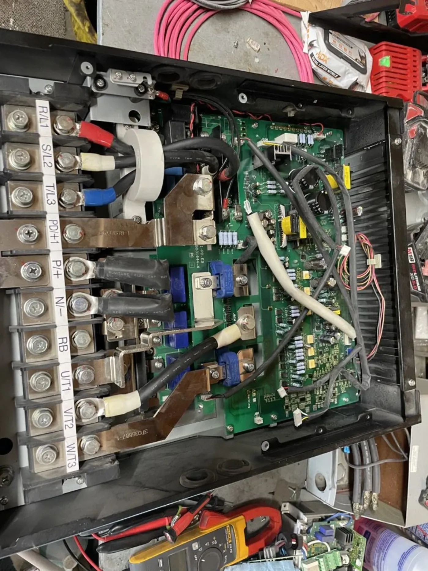 Opened variable frequency drive on the bench during repair, power terminals and control board exposed